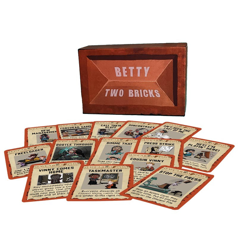 Some of the 35 Action Cards in party card game Betty Two Bricks spread out in a pile in front of the game box.