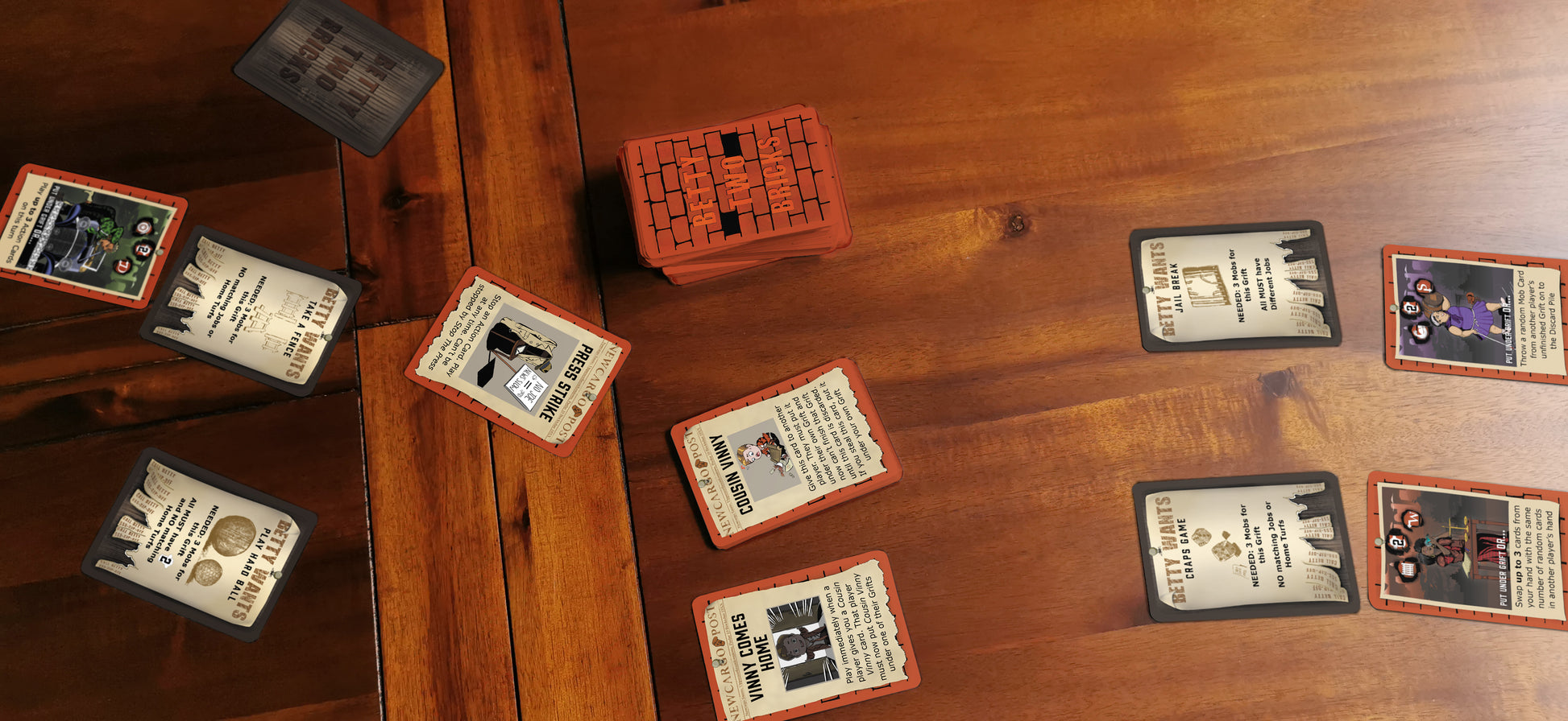 Cards from family tabletop game Betty Two Bricks in situ on a wooden table.
